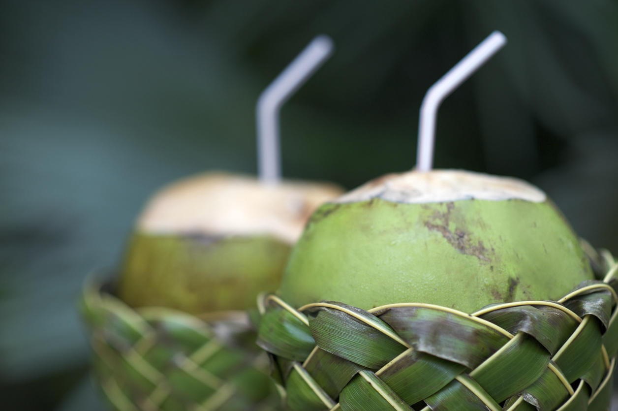 Fresh Coco Gelado Drinking Coconuts in Woven Basket